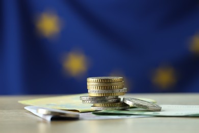 Photo of Coins and euro banknotes on table, closeup