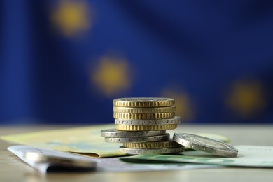 Photo of Coins and euro banknotes on table, closeup