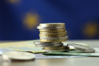 Photo of Coins and euro banknotes on table, closeup