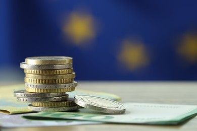 Photo of Coins and euro banknotes on table, closeup