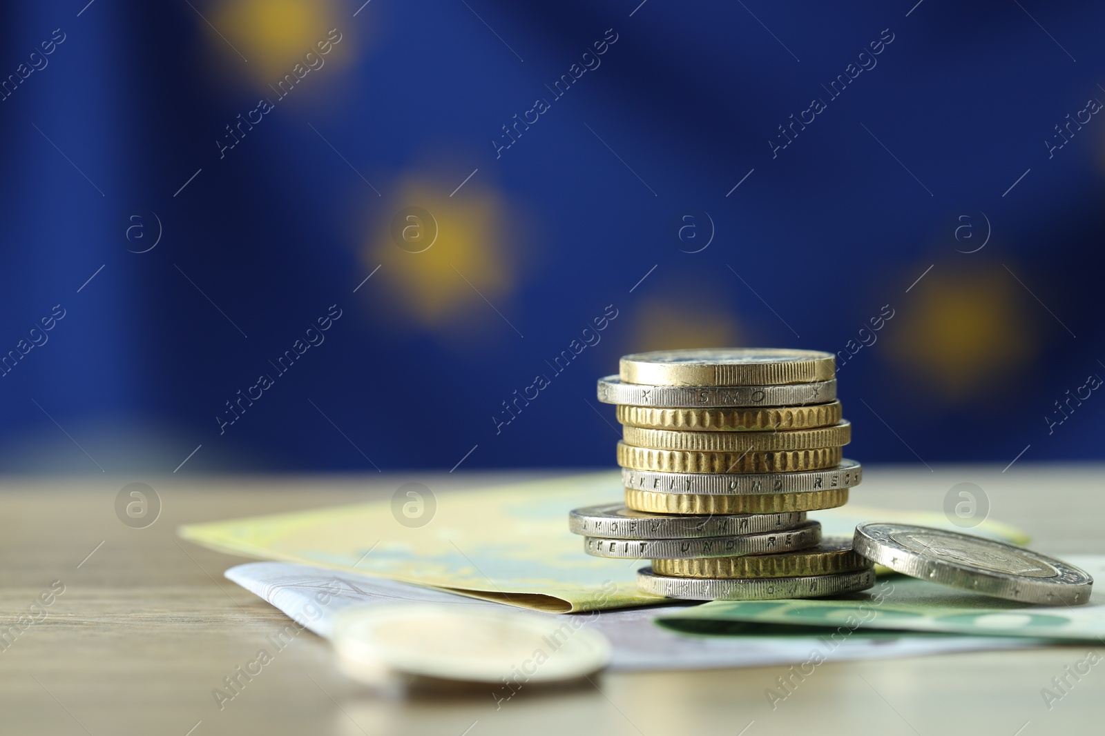 Photo of Coins and euro banknotes on table, closeup