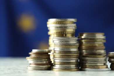 Stacks of euro coins on table, closeup