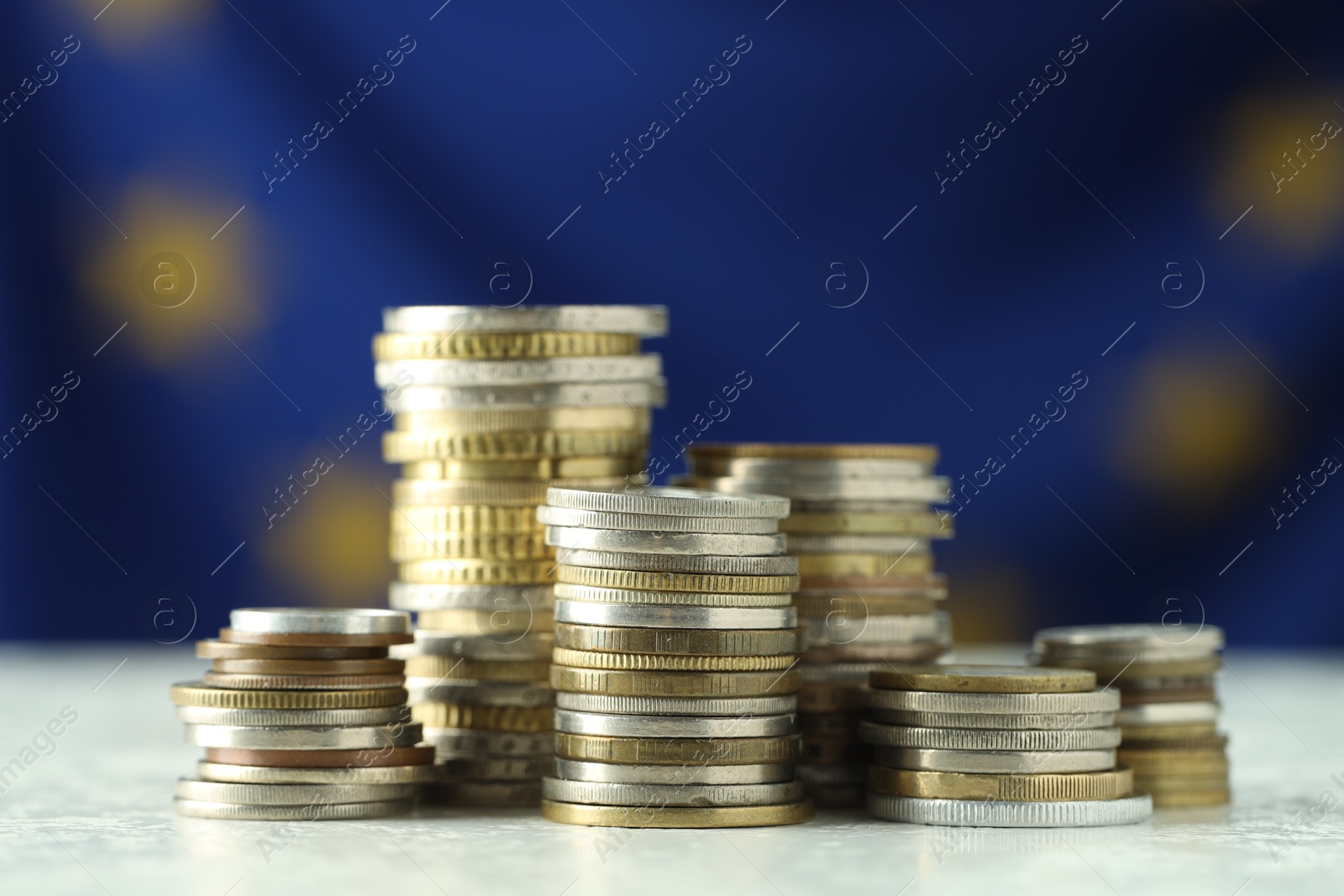 Photo of Stacks of euro coins on table, closeup