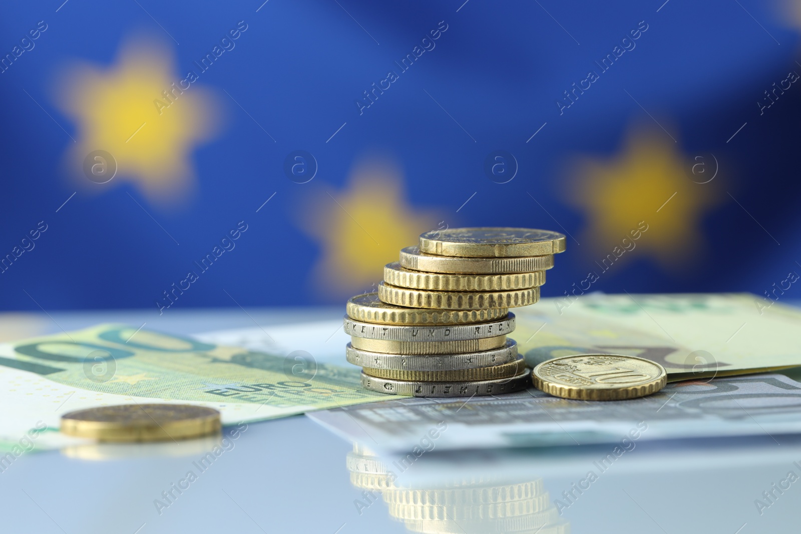 Photo of Coins and euro banknotes on table, closeup