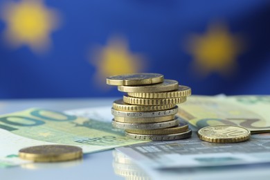 Photo of Coins and euro banknotes on table, closeup