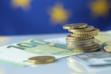 Photo of Coins and euro banknotes on table, closeup