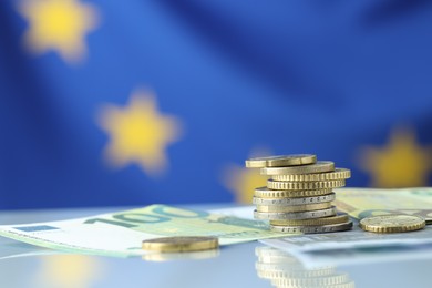 Photo of Coins and euro banknotes on table, closeup