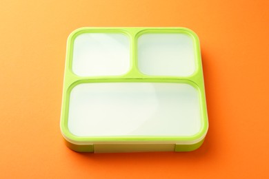 One lunch box on orange background, above view