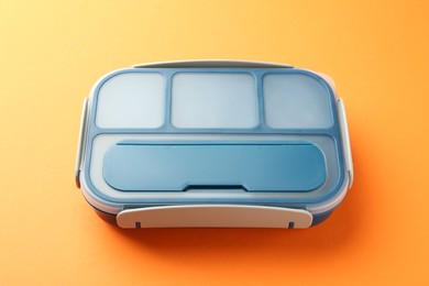 One bright lunch box on orange background