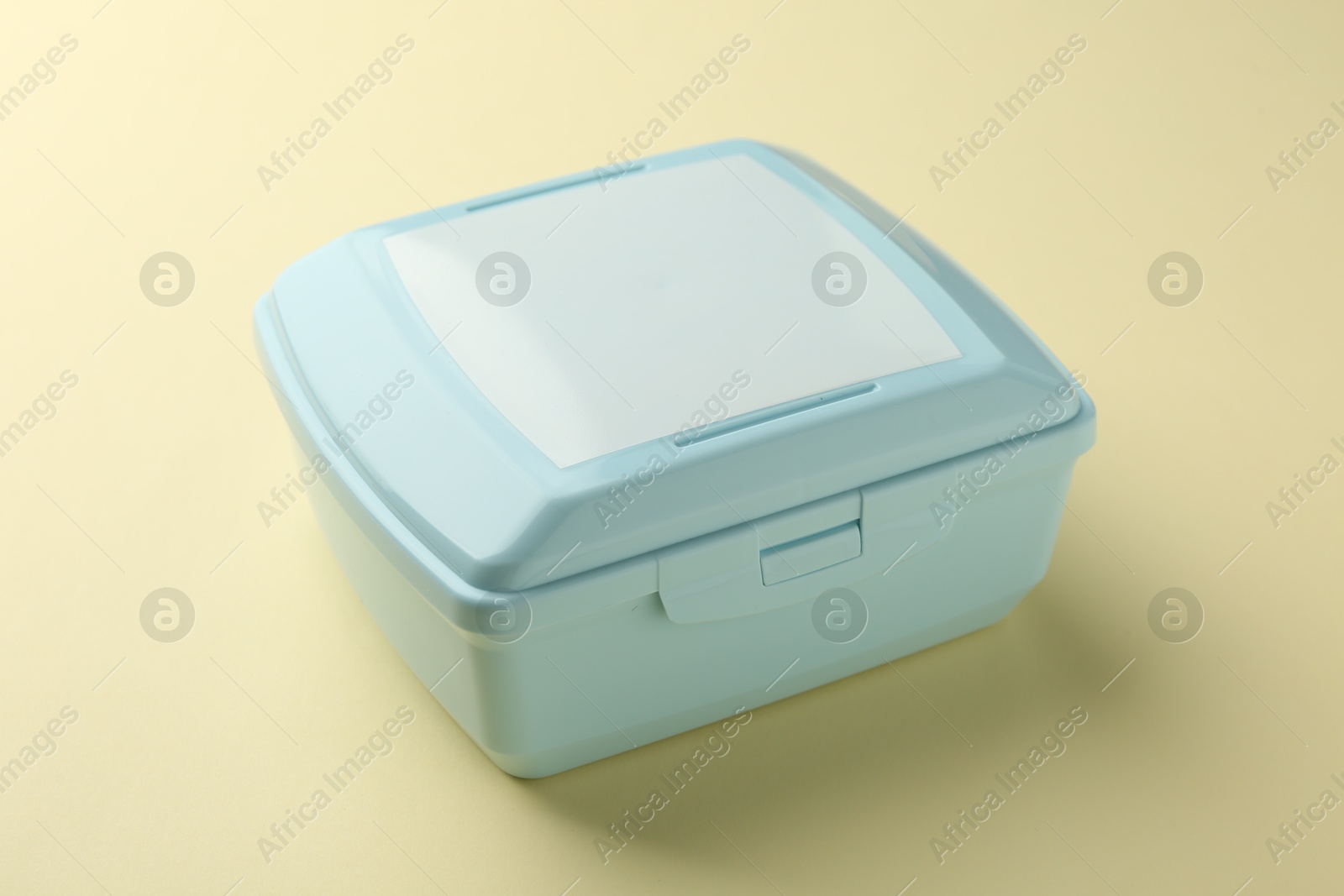 Photo of One light blue lunch box on beige background