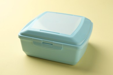 Photo of One light blue lunch box on beige background