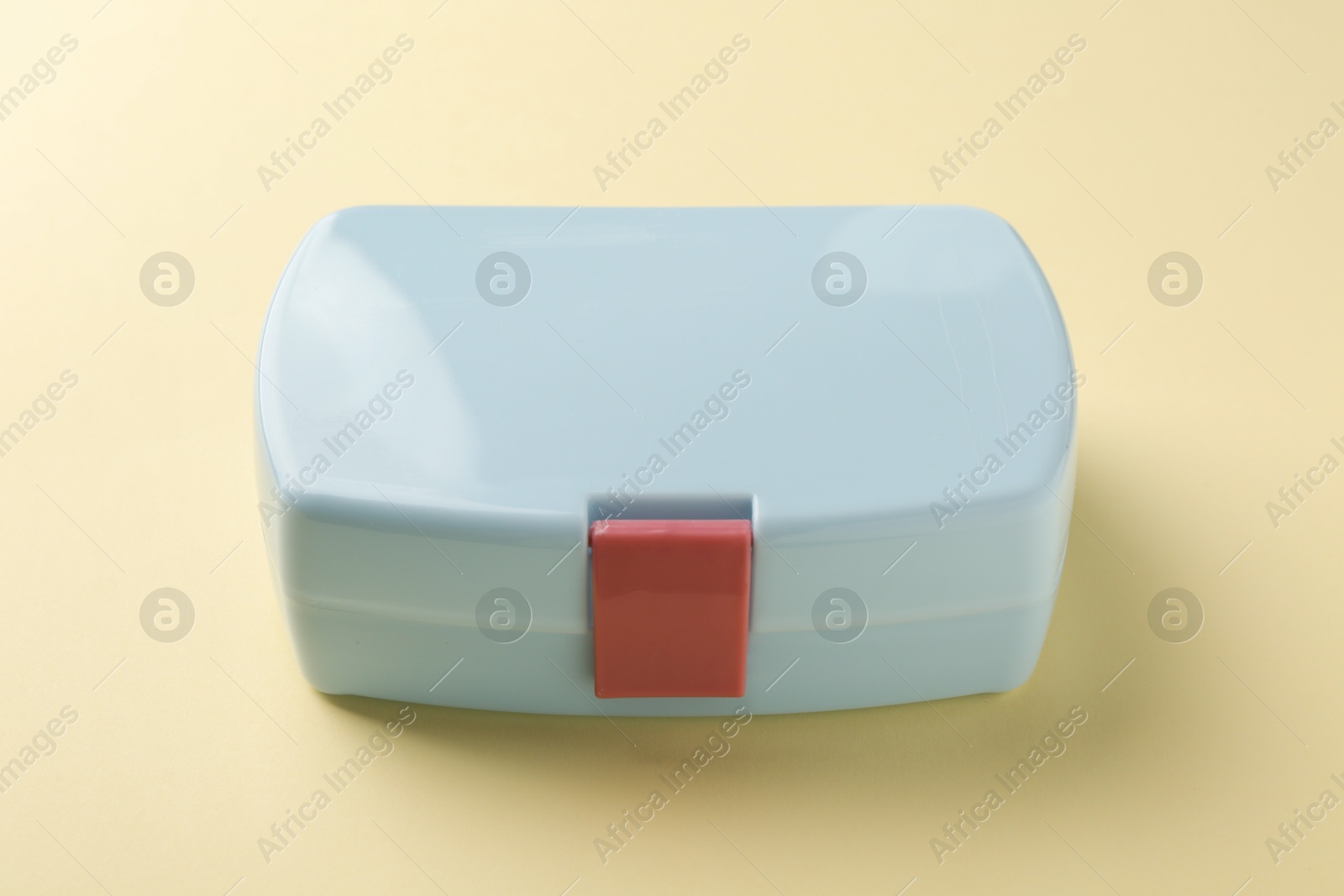 Photo of One light blue lunch box on beige background