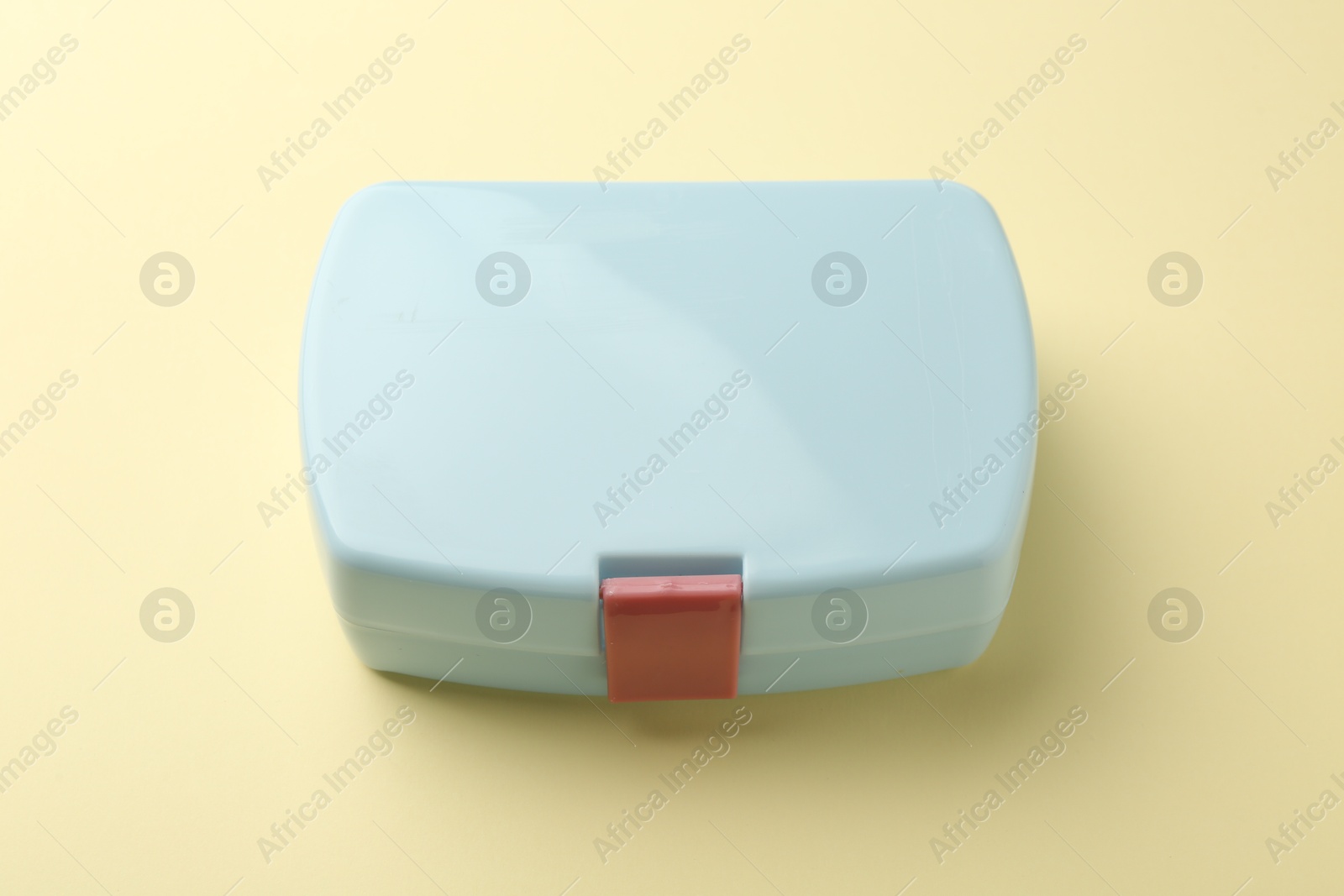 Photo of One lunch box on beige background, above view