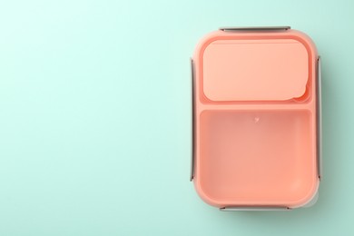 Photo of One empty lunch box on light blue background, top view. Space for text