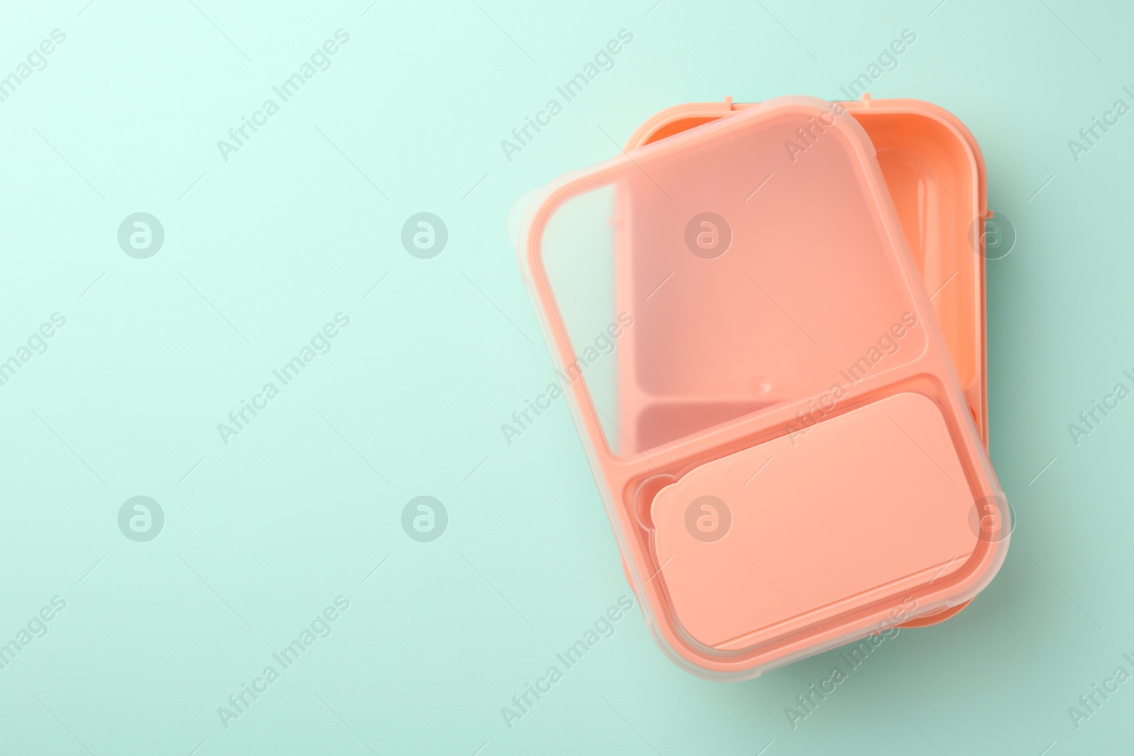 Photo of One empty lunch box on light blue background, top view. Space for text