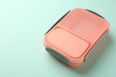 Photo of One empty lunch box on light blue background, space for text