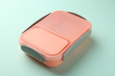 Photo of One empty lunch box on light blue background