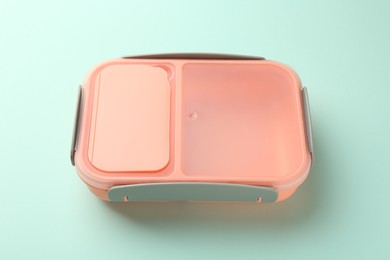 Photo of One empty lunch box on light blue background