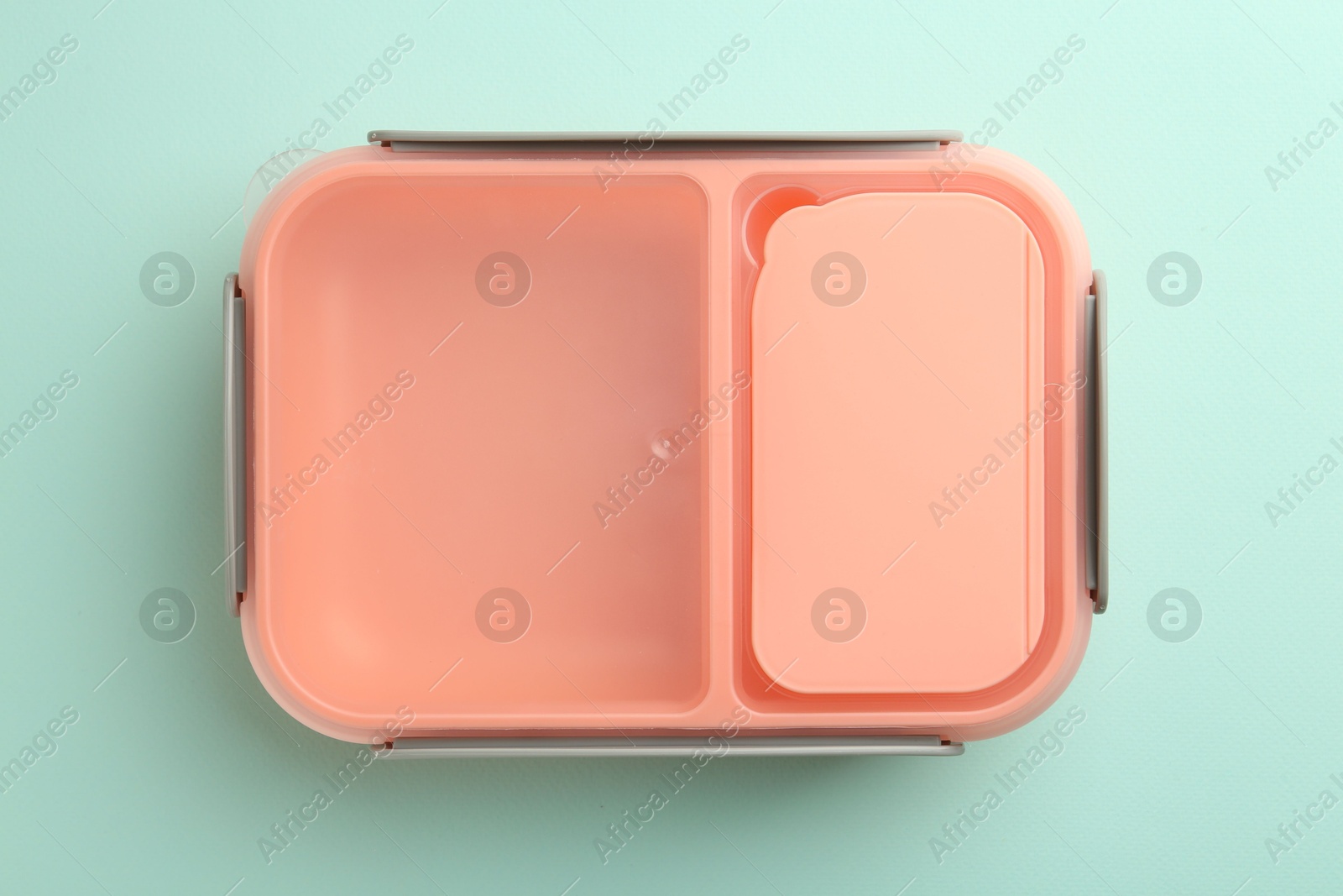 Photo of One empty lunch box on light blue background, top view