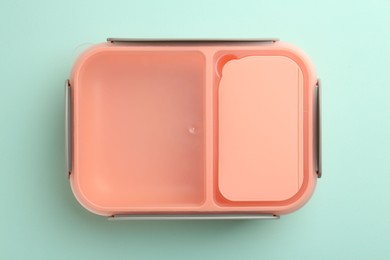 Photo of One empty lunch box on light blue background, top view