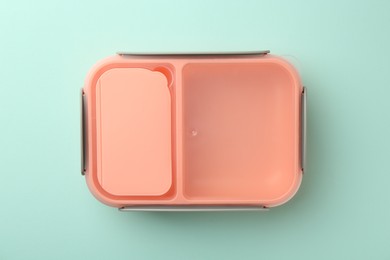 Photo of One empty lunch box on light blue background, top view