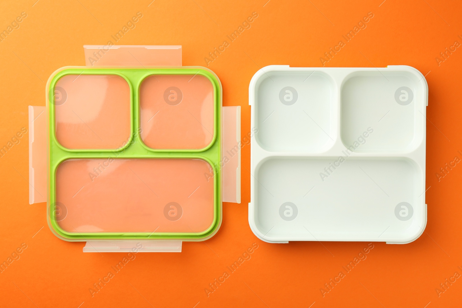 Photo of One empty lunch box on orange background, flat lay