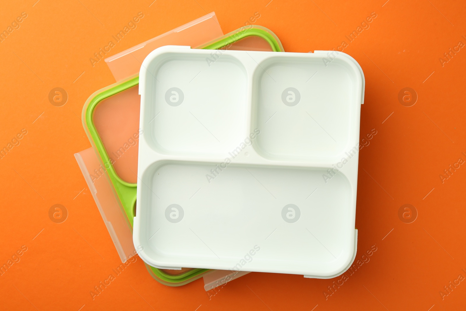 Photo of One empty lunch box on orange background, flat lay