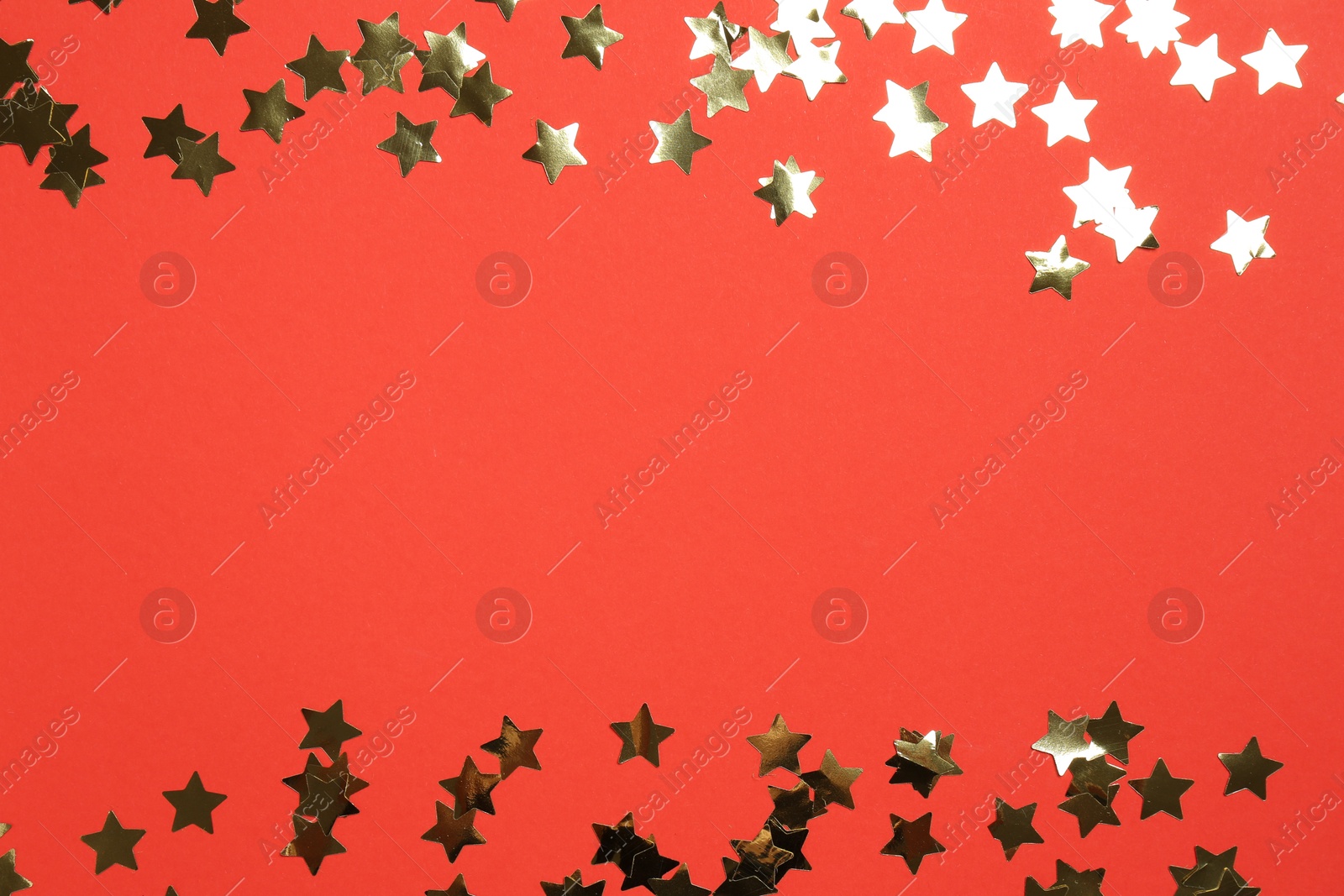 Photo of Shiny confetti on red background, flat lay. Space for text