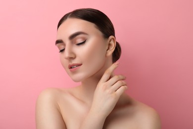 Gorgeous woman with perfect skin on pink background