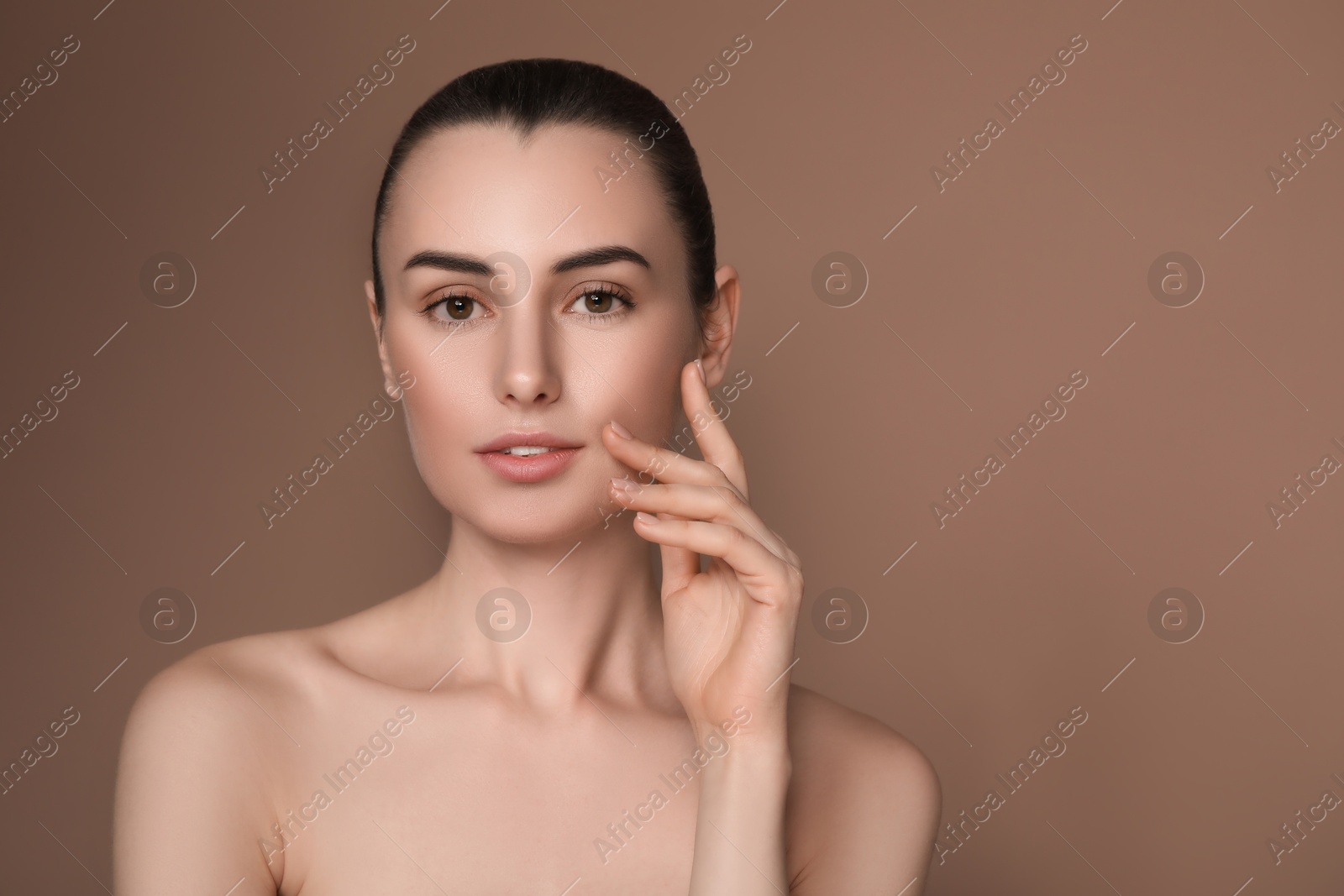 Image of Gorgeous woman with perfect skin on brown background