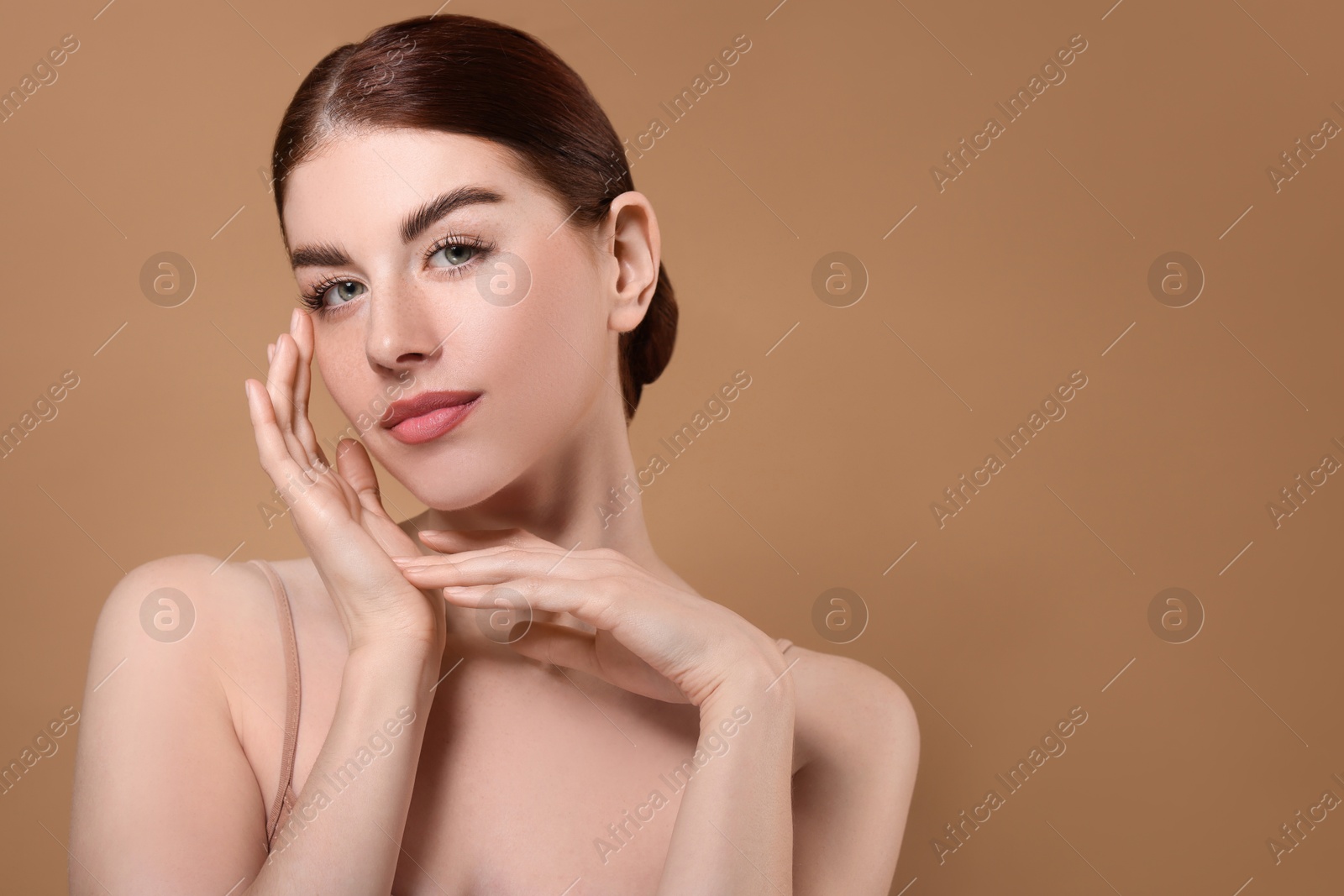 Image of Attractive woman with perfect skin on light brown background