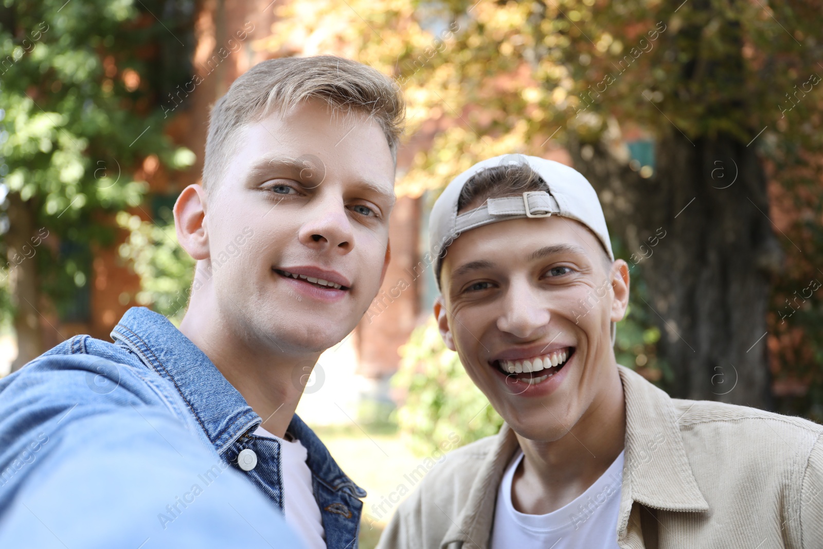 Photo of Family portrait of happy brothers outdoors on sunny day