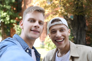 Photo of Family portrait of happy brothers outdoors on sunny day