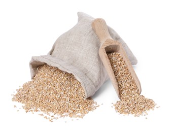 Photo of Dry wheat groats, overturned burlap sack and wooden scoop isolated on white