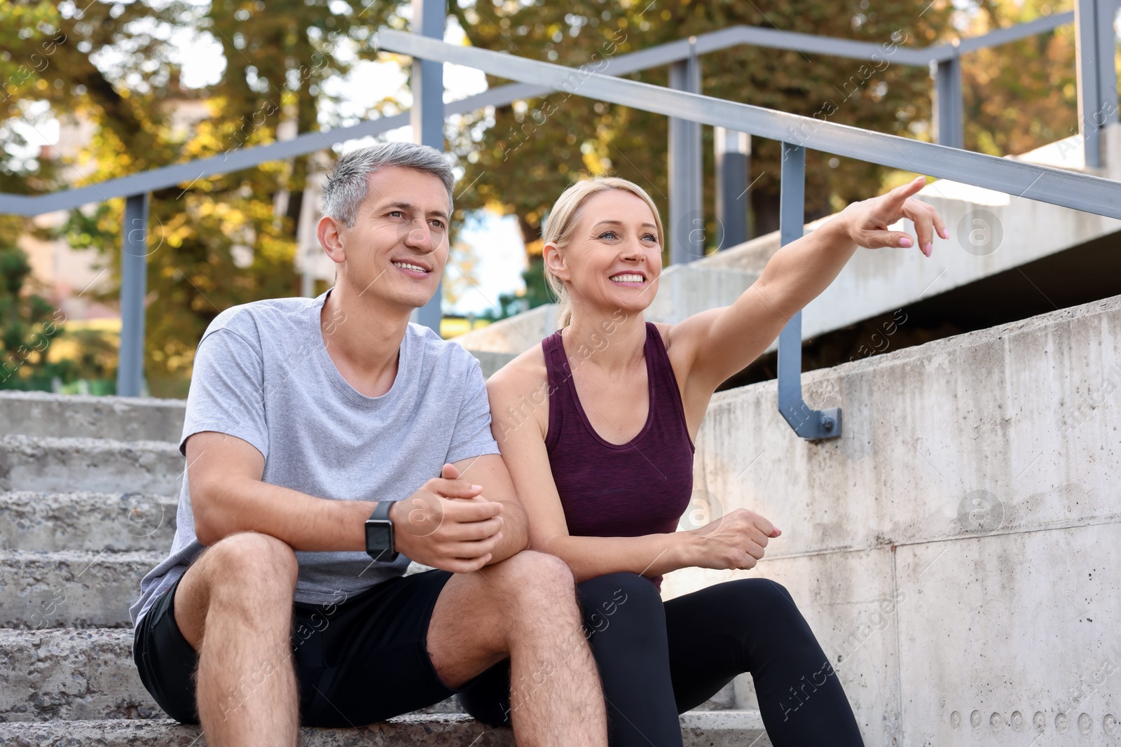 Photo of Portrait of smiling couple on steps outdoors