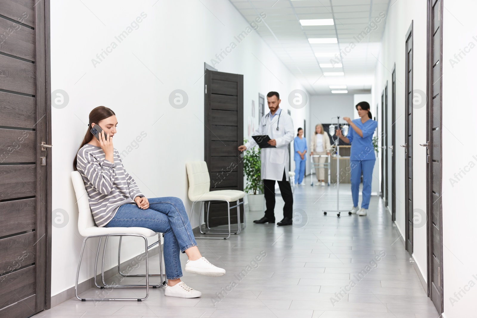 Photo of Patients and doctors in hospital hallway, selective focus