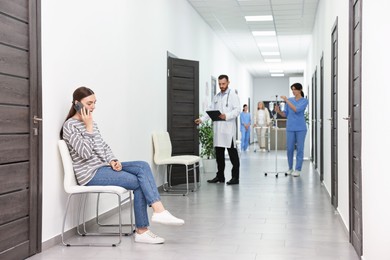 Patients and doctors in hospital hallway, selective focus