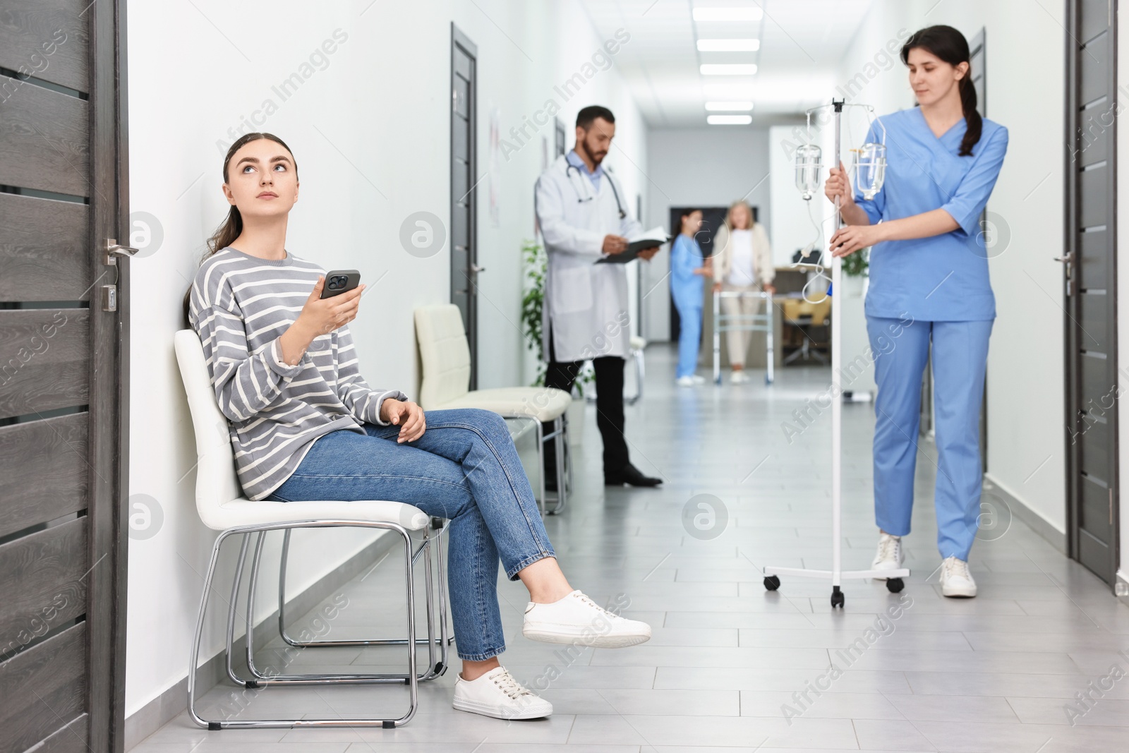 Photo of Patients and doctors in hospital hallway, selective focus