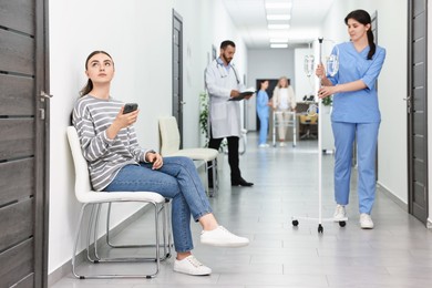 Patients and doctors in hospital hallway, selective focus