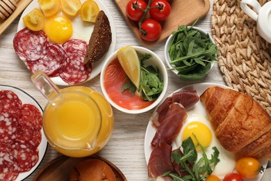 Photo of Different tasty food served for brunch on white wooden table, flat lay