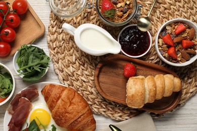 Photo of Different tasty food served for brunch on white wooden table, flat lay