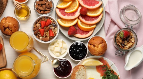 Photo of Different tasty food served for brunch on white wooden table, flat lay