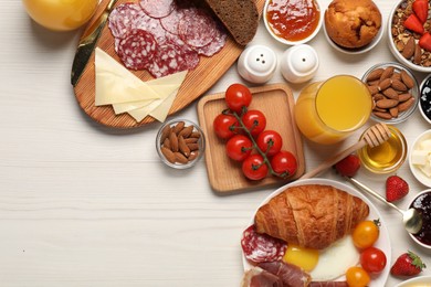 Photo of Different tasty food served for brunch on white wooden table, flat lay. Space for text