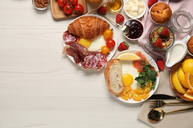 Photo of Different tasty food served for brunch on white wooden table, flat lay. Space for text