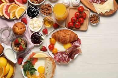 Photo of Different tasty food served for brunch on white wooden table, flat lay. Space for text