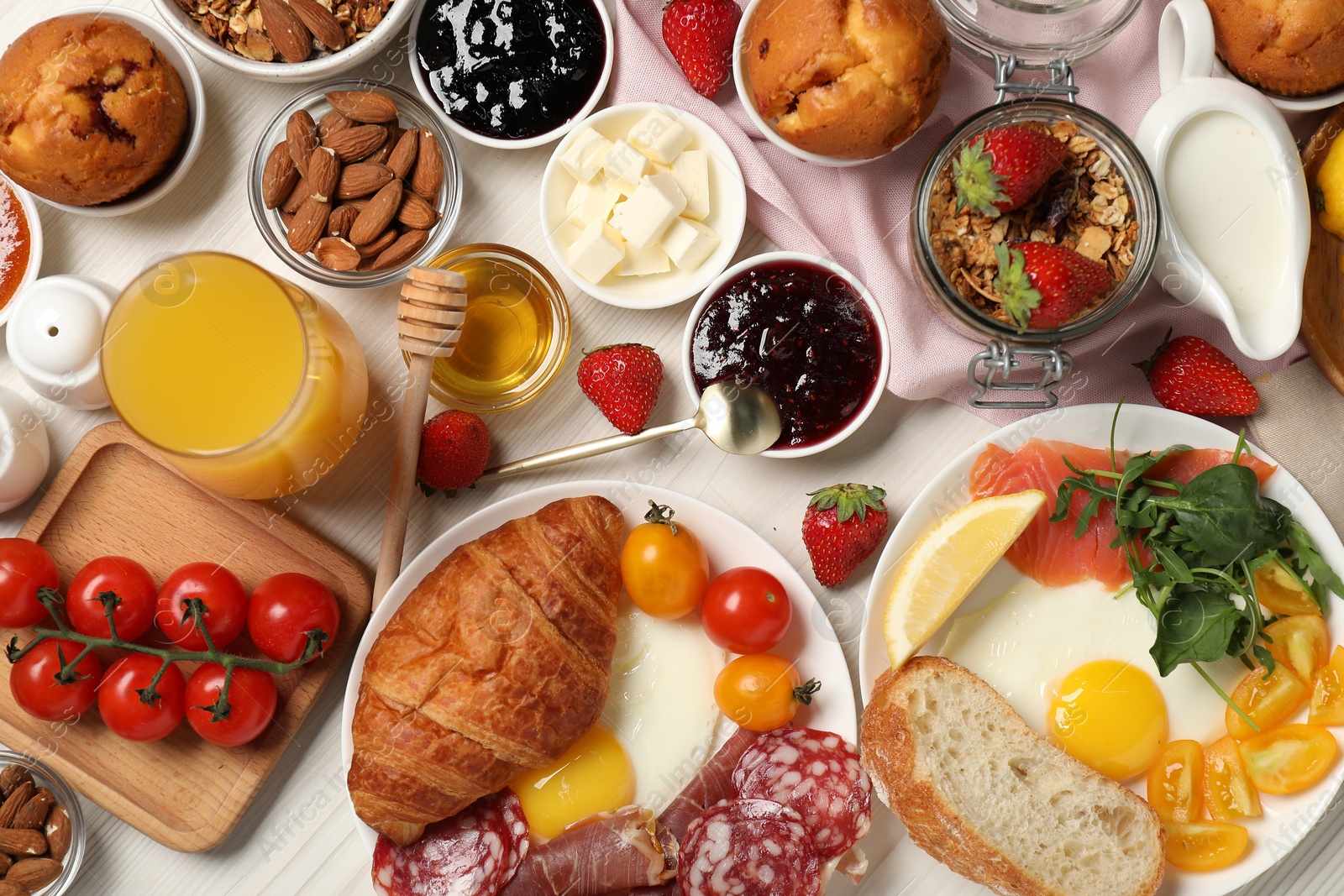 Photo of Different tasty food served for brunch on white wooden table, flat lay