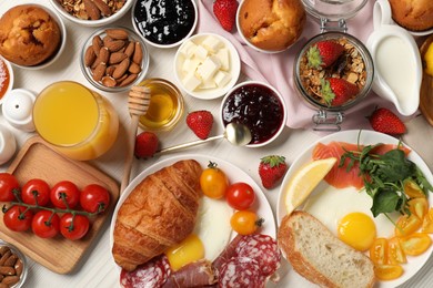 Photo of Different tasty food served for brunch on white wooden table, flat lay