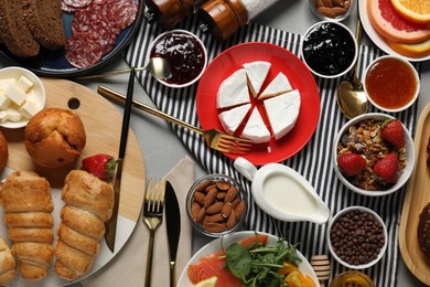 Photo of Different tasty food served for brunch on grey table, flat lay