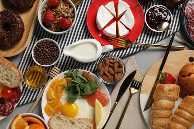 Photo of Different tasty food served for brunch on grey table, flat lay