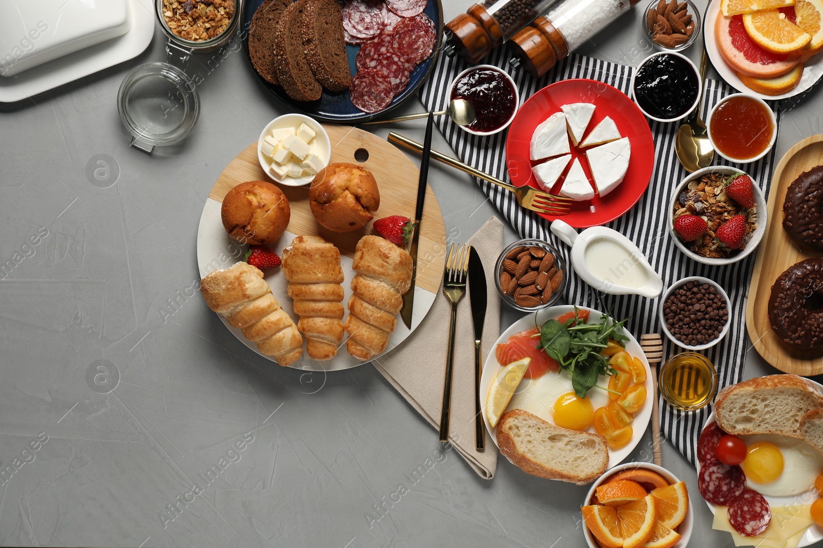 Photo of Different tasty food served for brunch on grey table, flat lay